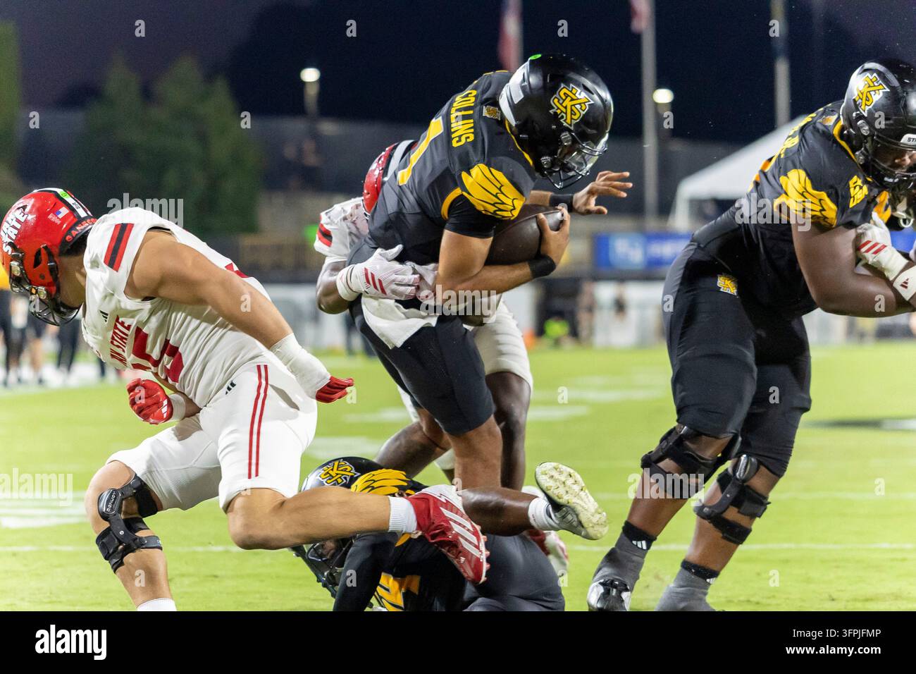 Kennesaw State quarterback Rickie Collins (1) dives into the end zone ...