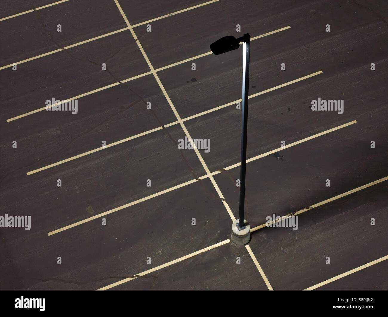 Dark asphalt parking lot with crisp white lines Stock Photo