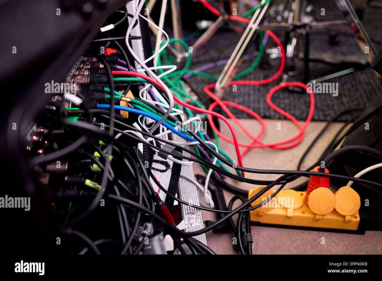 Tangled network of multicolored electrical cables and connectors Stock Photo