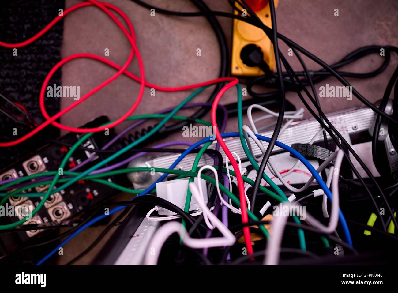 Tangled network of multicolored electrical cables and connectors Stock Photo