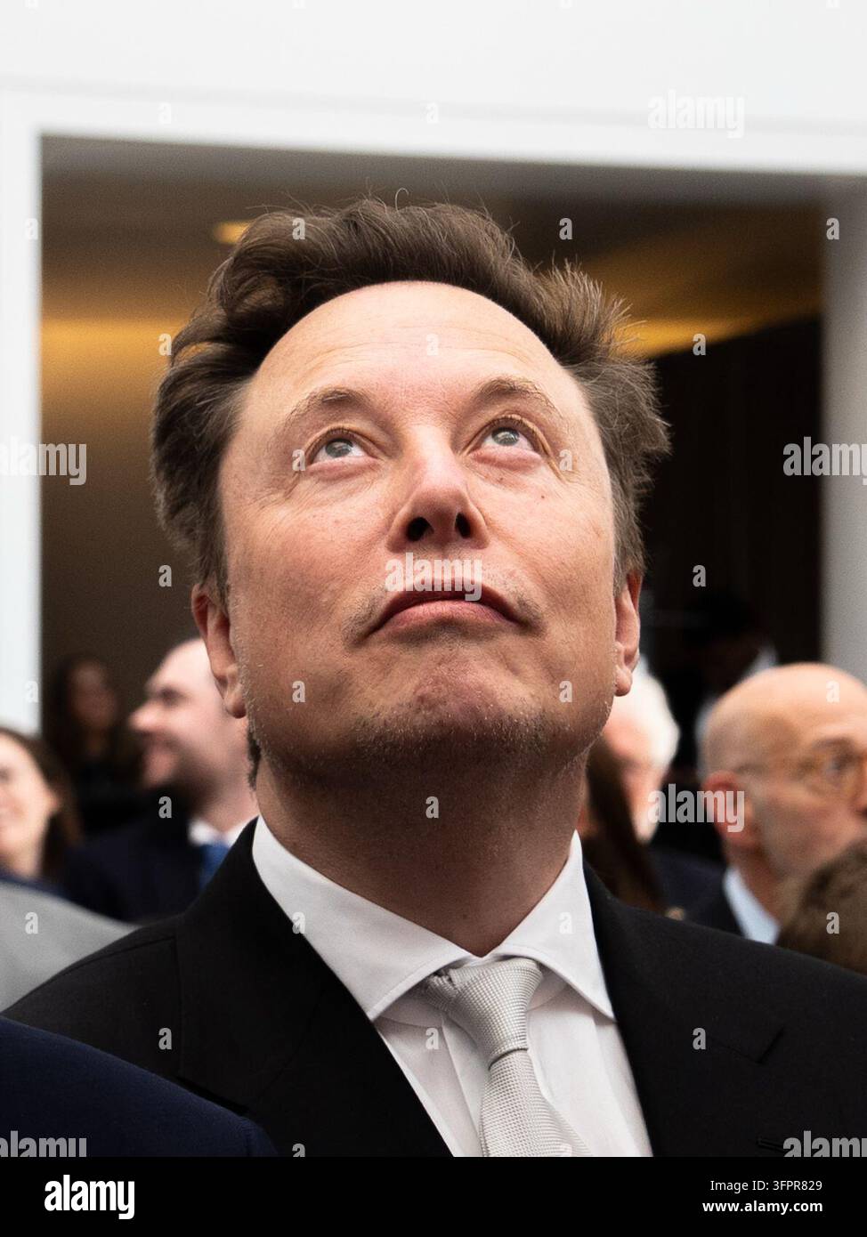 Elon Musk listens to President Donald Trump speak at the U.S. Institute ...