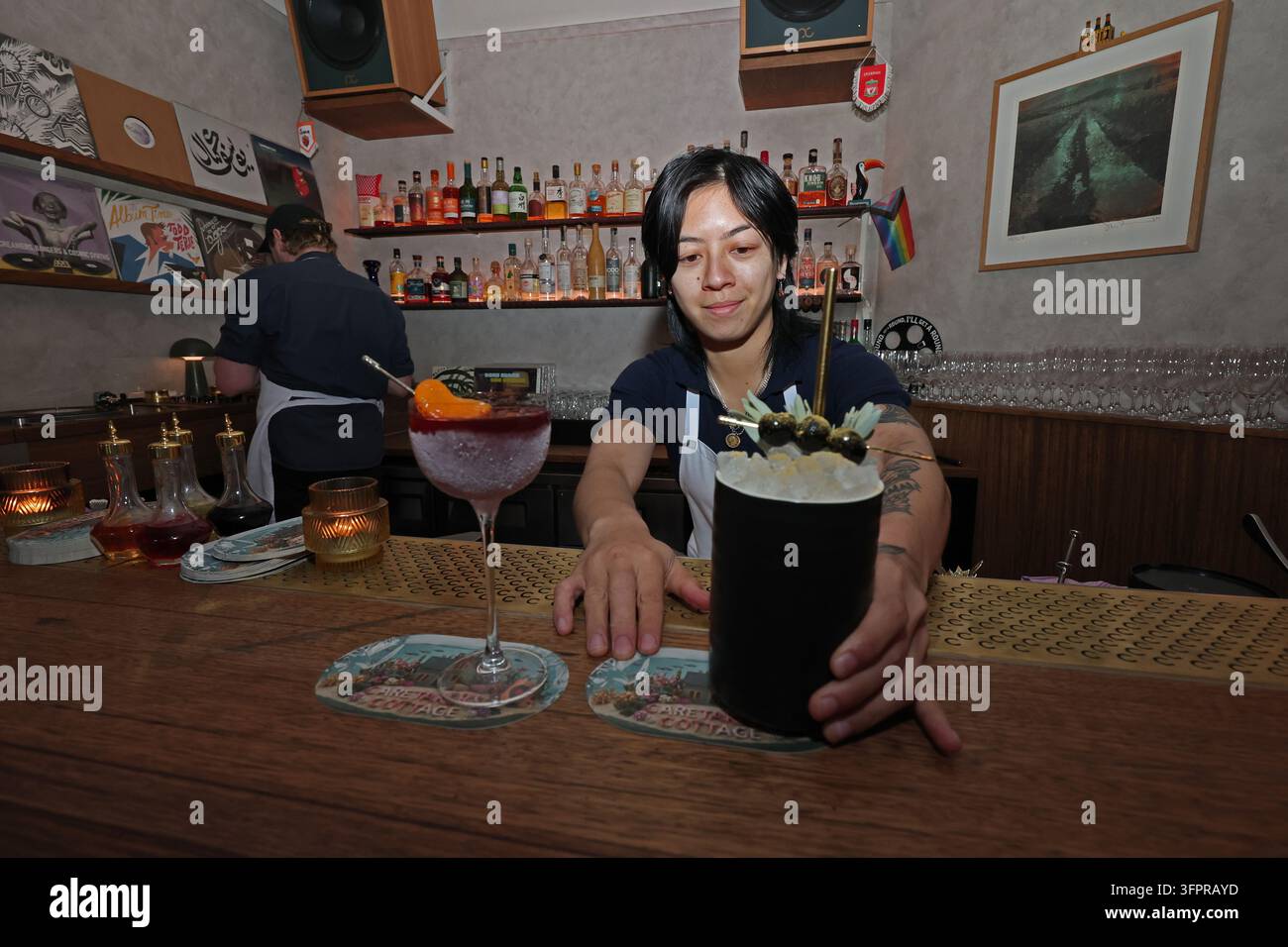 Sign Modle Image Bar tender Chantalle Narith (R) at Caretaker's Cottage, which has been ...