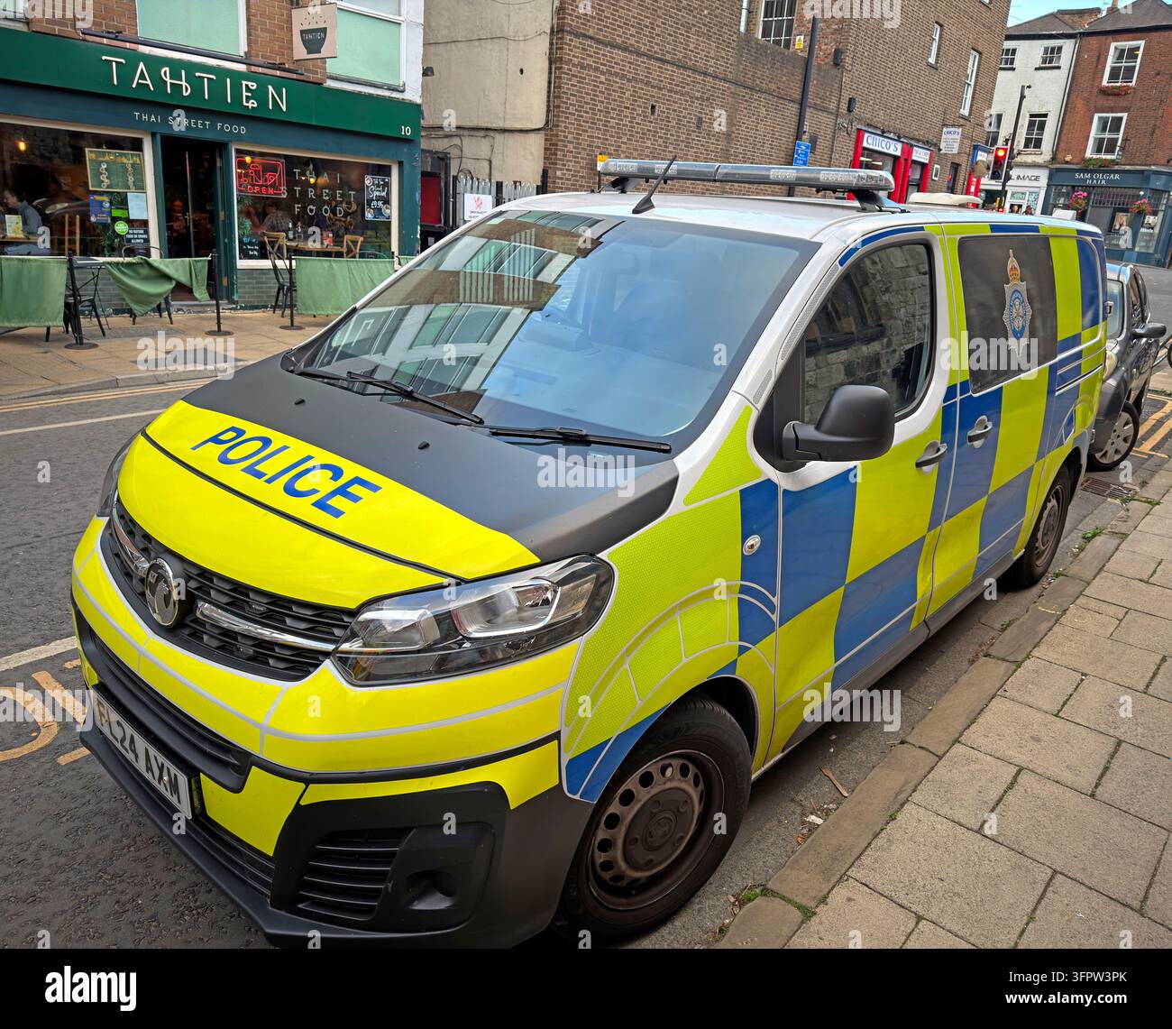 A marked North Yorkshire Police Vauxhall Vivaro van is parked beside a stone building in central York. Stock Photo