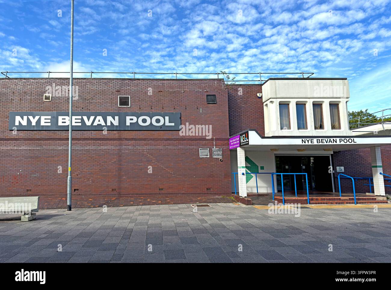 The exterior of Nye Bevan Pool leisure building in Skelmersdale, with its name prominently displayed on a long brick wall. Stock Photo