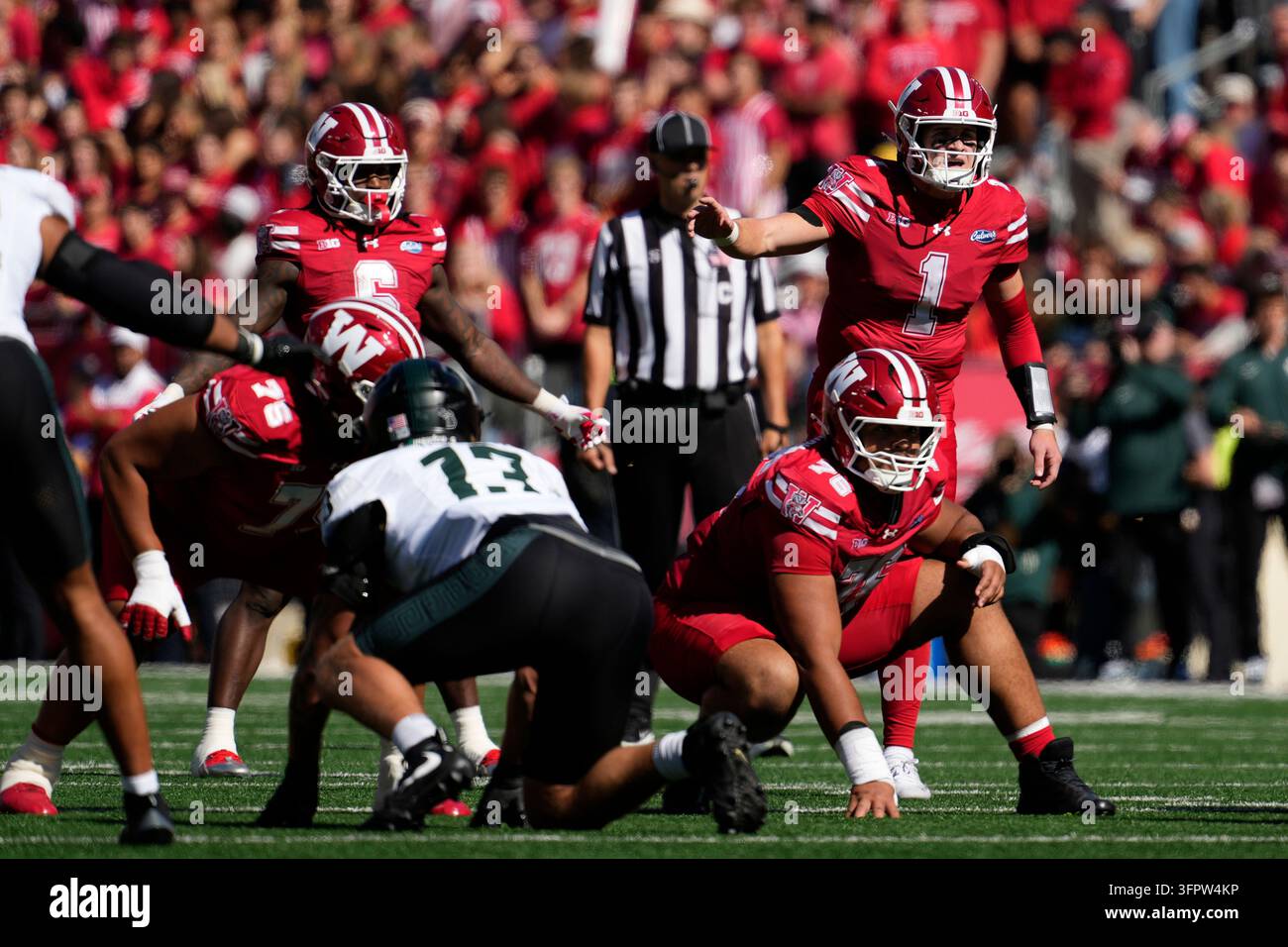 Wisconsin's Colton Joseph gestures at the line of scrimmage during an ...