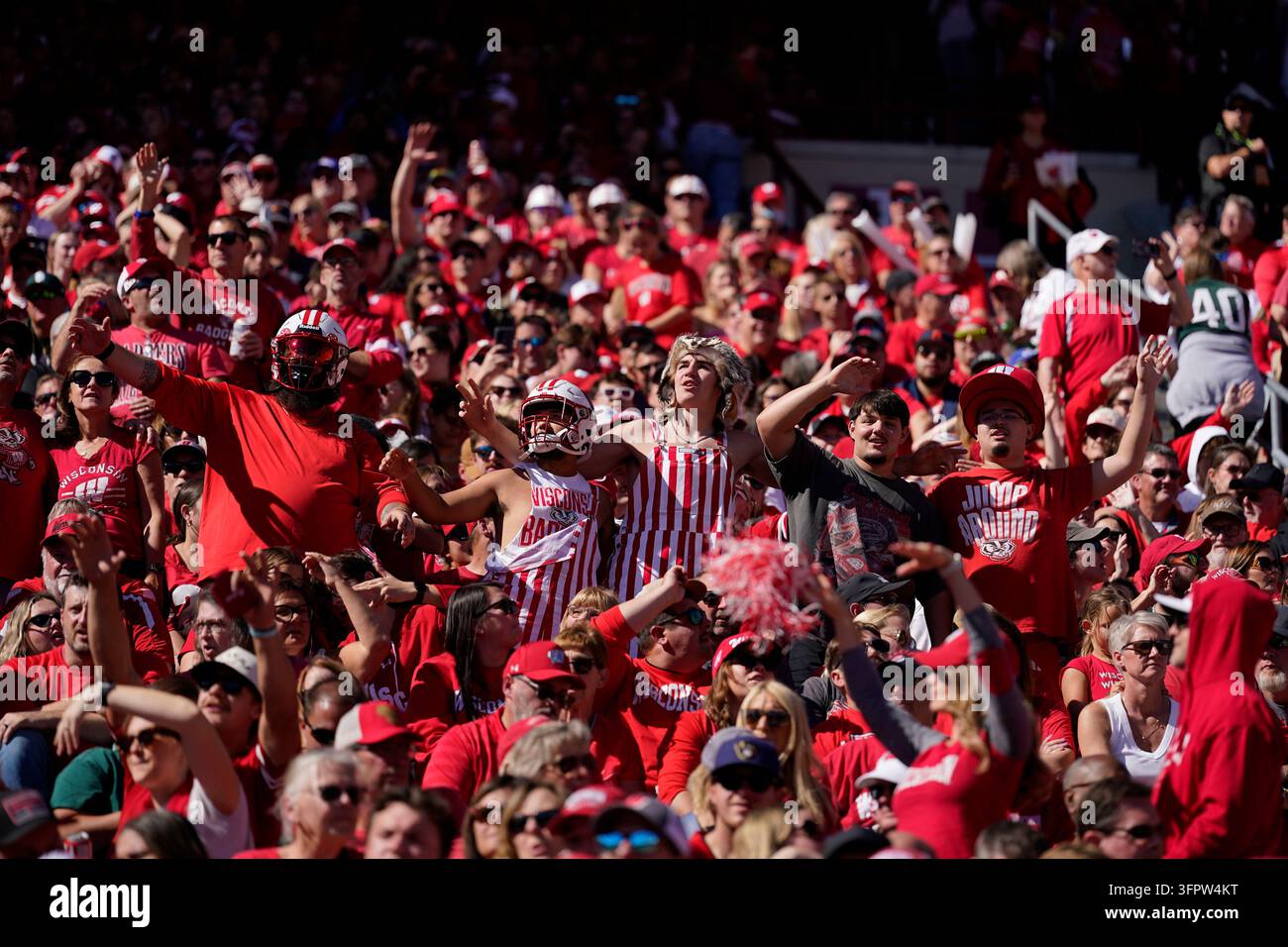 Fans cheer during an NCAA college football game between Wisconsin and ...