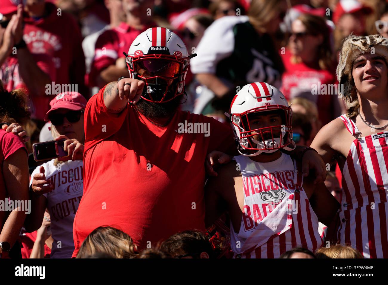 Fans cheer during an NCAA college football game between Wisconsin and ...