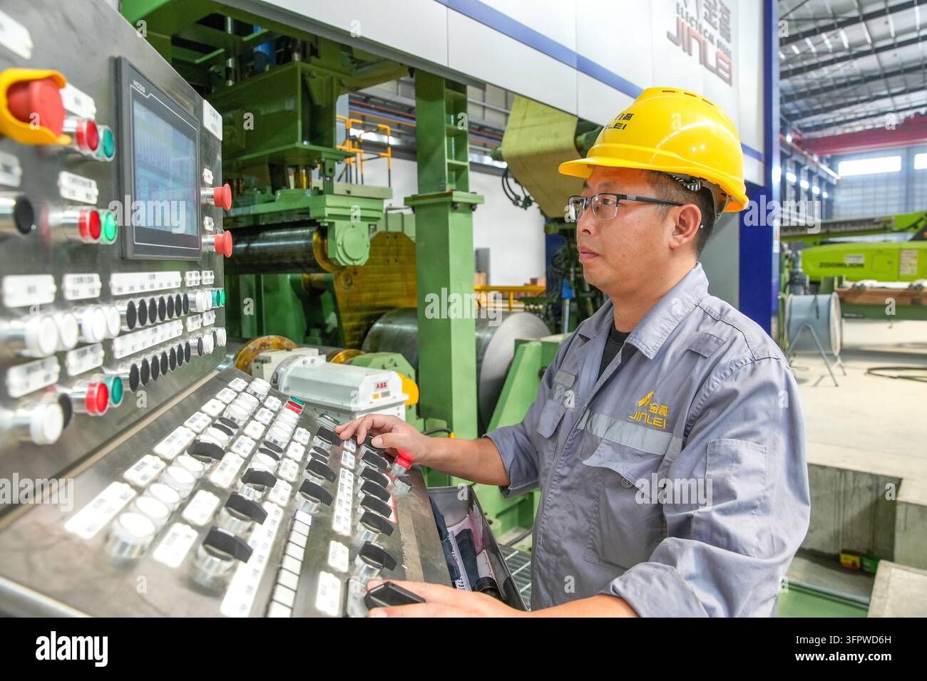 HUZHOU, CHINA - OCTOBER 9, 2026 - A staff member is debugging equipment ...