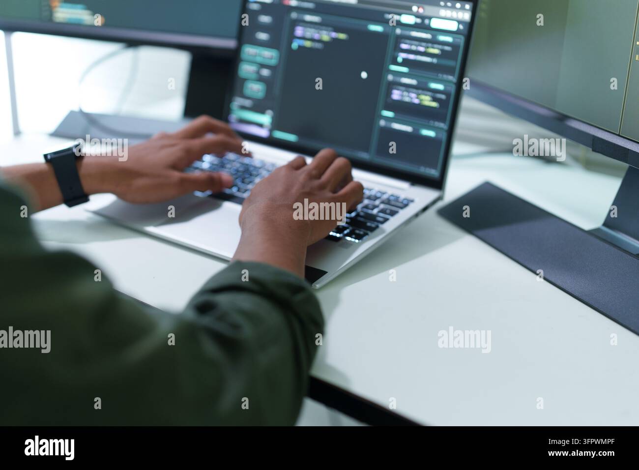 Close up of a programmer coding on a laptop computer Stock Photo