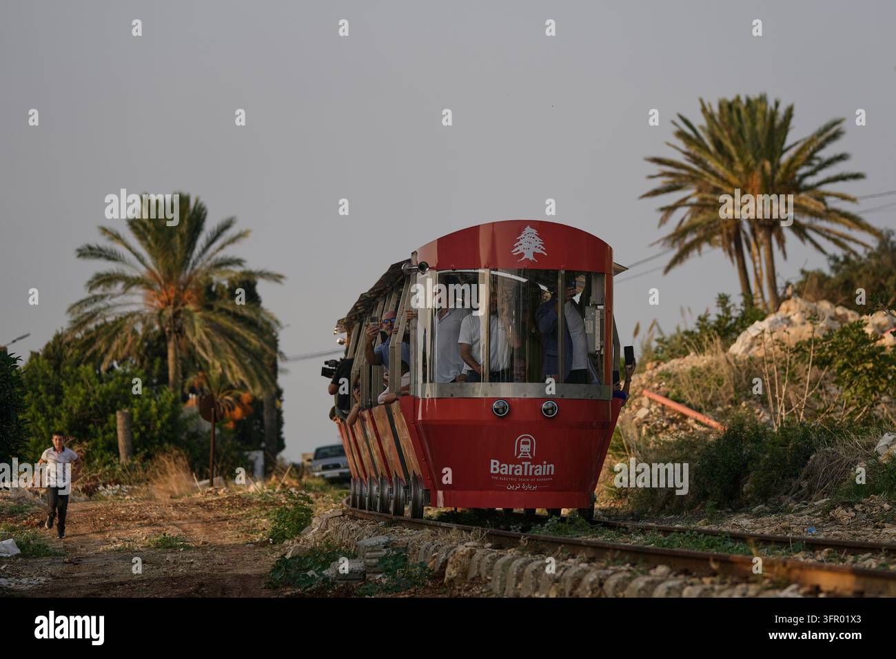 Trains Rides Open Sign People ride a locally built electric train in the northern Lebanese ...