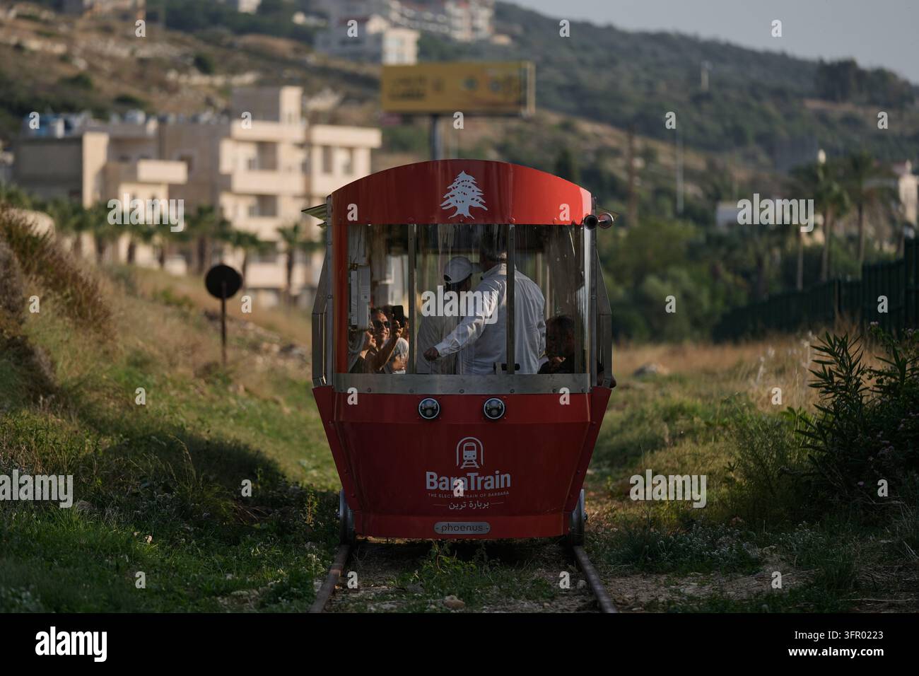 Trains Rides Open Sign People ride a locally built electric train in the northern Lebanese ...