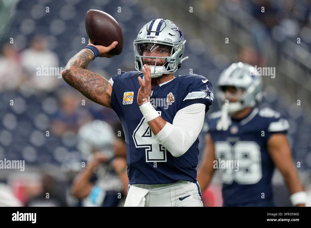 Dallas Cowboys quarterback Dak Prescott warms up before an NFL football ...