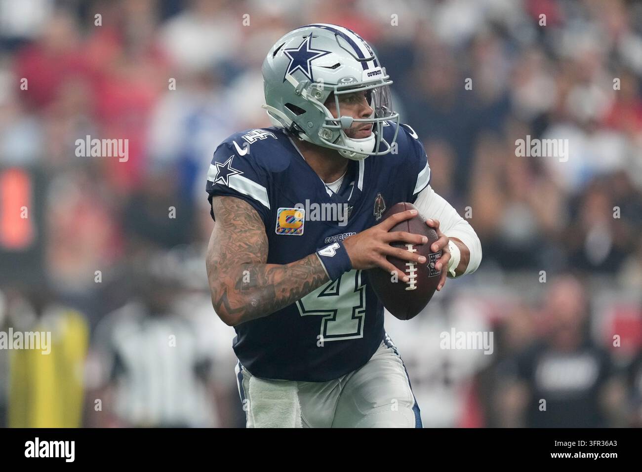 Dallas Cowboys quarterback Dak Prescott looks for a receiver during an ...