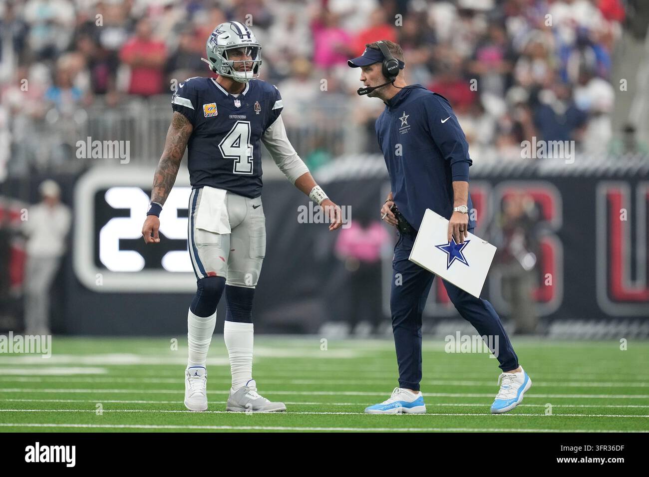 Dallas Cowboys quarterback Dak Prescott (4) talks with head coach Brian ...