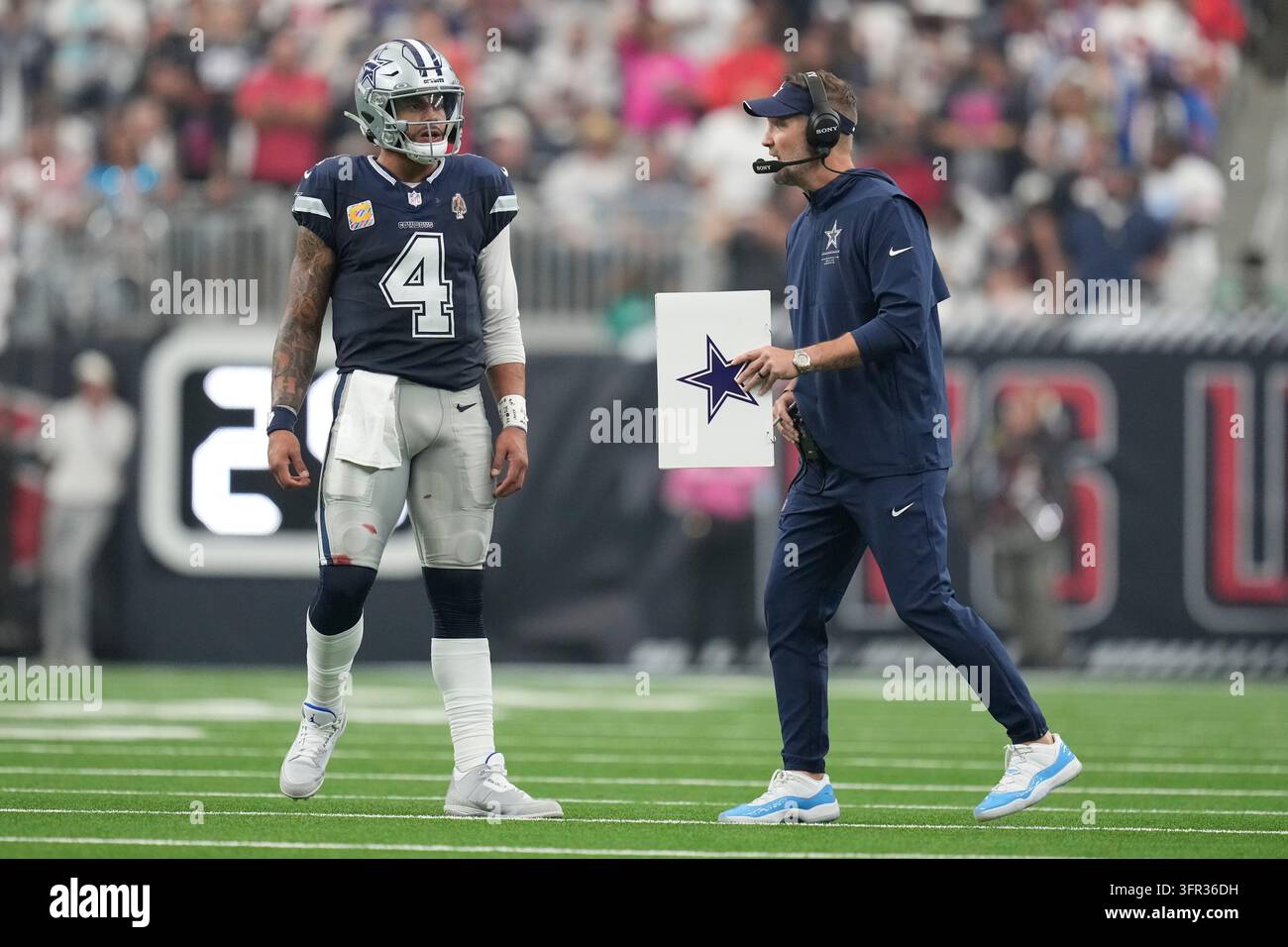 Dallas Cowboys quarterback Dak Prescott (4) talks with head coach Brian ...