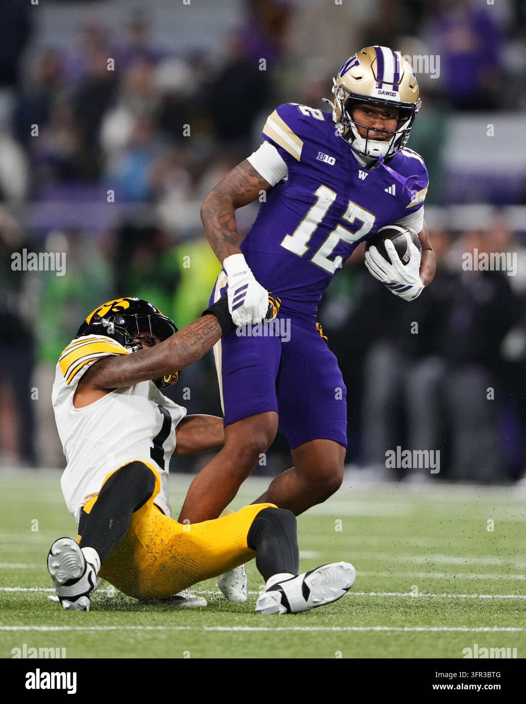 Trez Washington wide receiver Trez Davis (12) is tackled by Iowa defensive ...