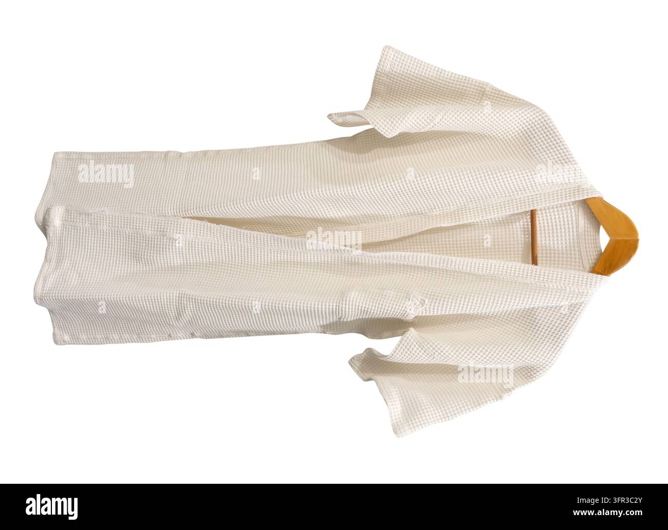 White bathrobe hanging is isolated on white background with clipping path. Stock Photo