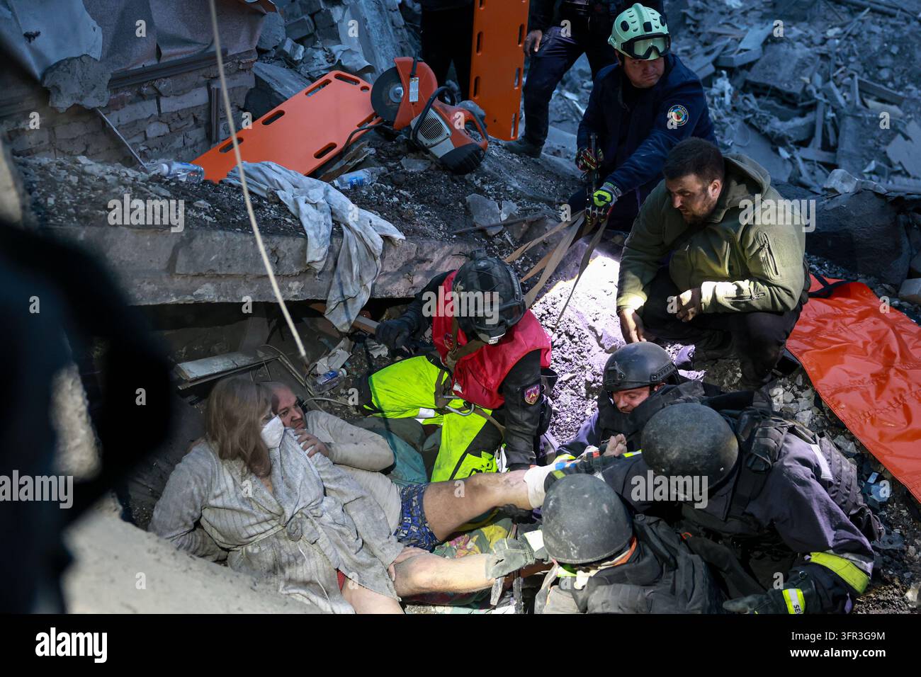File Rescue Software Rescue workers pull a family from the rubble of a residential building ...