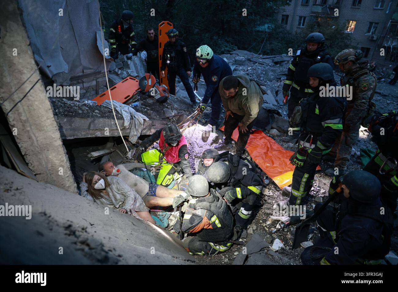 File Rescue Software Rescue workers pull a family from the rubble of a residential building ...