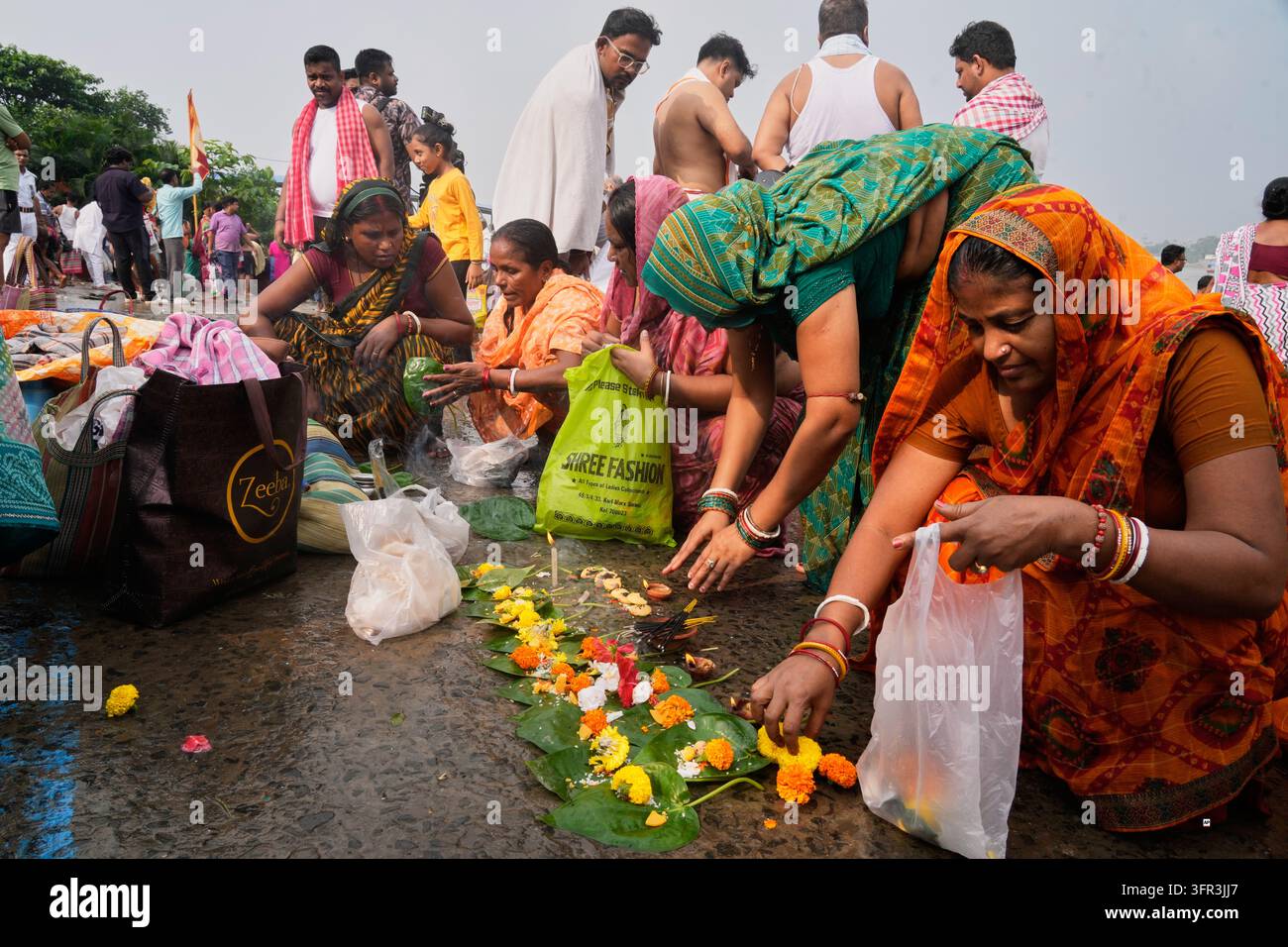 Perform Rituals Hindu devotees perform rituals on the banks of the Hooghly River on the ...