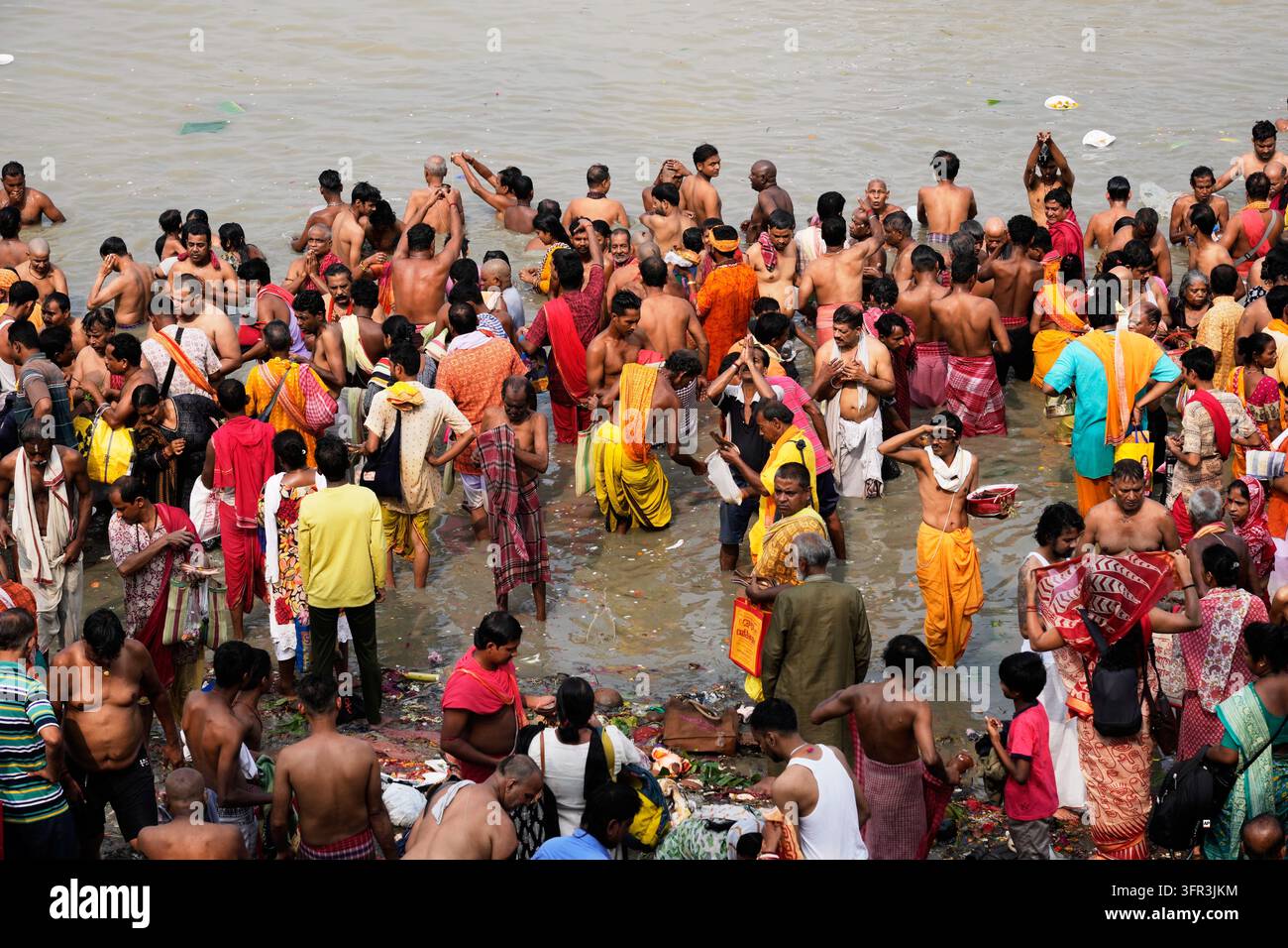 Perform Rituals Hindu devotees perform rituals on the banks of the Hooghly River on the ...