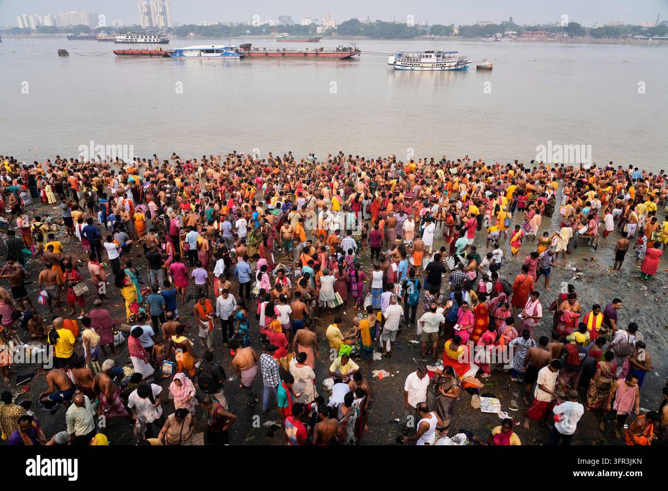 Perform Rituals Hindu devotees perform rituals on the banks of the Hooghly River on the ...