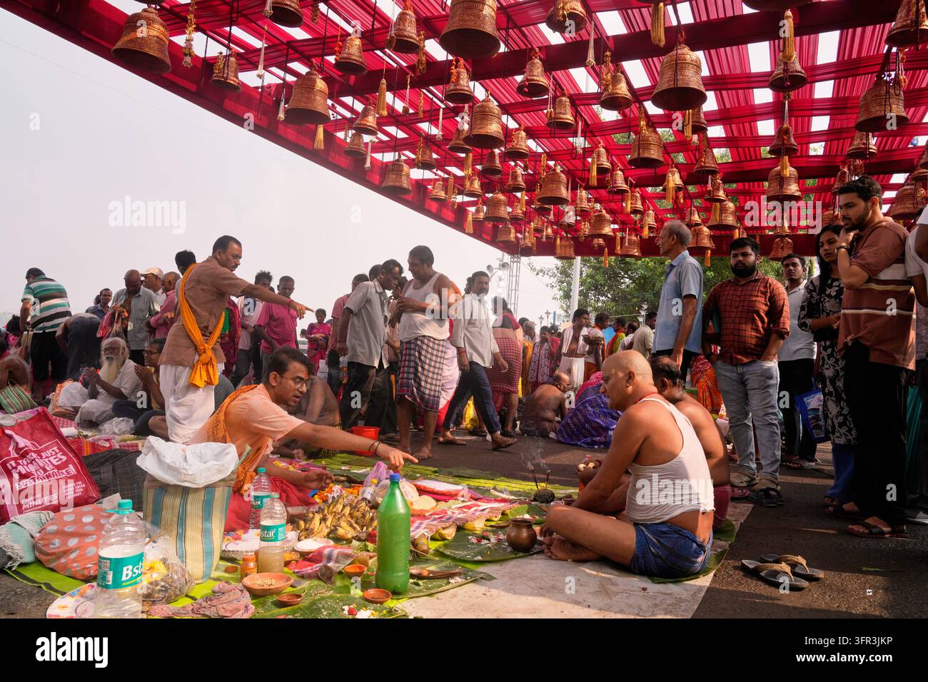 Perform Rituals Hindu priests gesture as devotees perform rituals on the banks of the ...