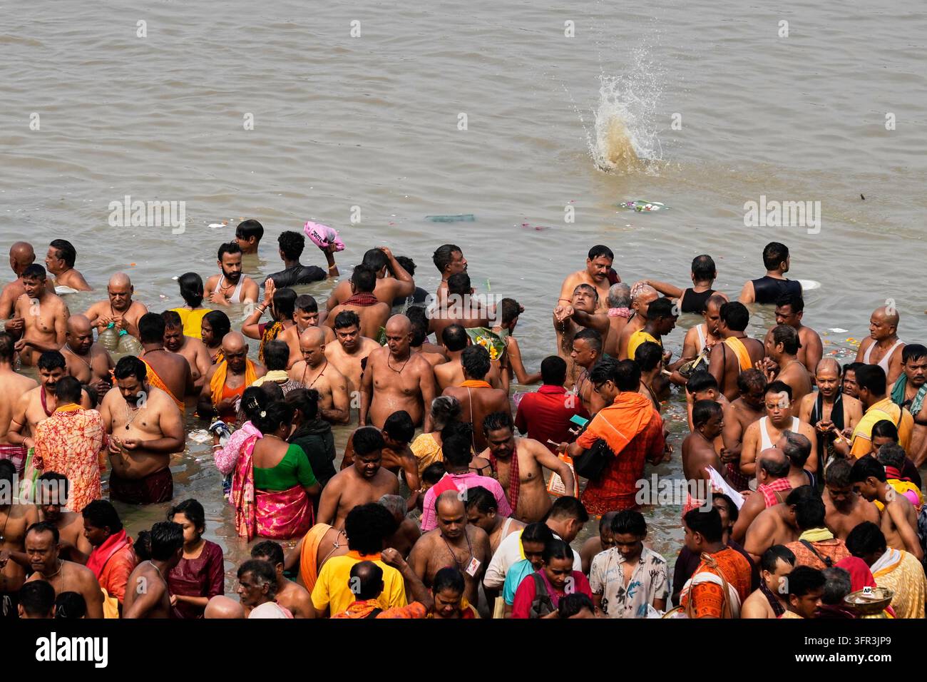 Perform Rituals Hindu devotees perform rituals on the banks of the Hooghly River on the ...