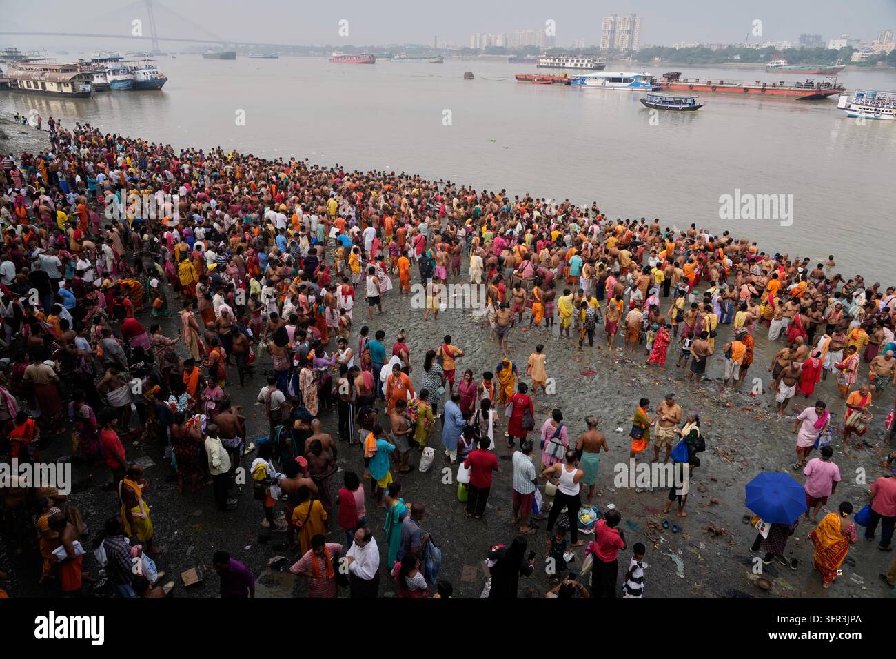 Perform Rituals Hindu devotees perform rituals on the banks of the Hooghly River on the ...