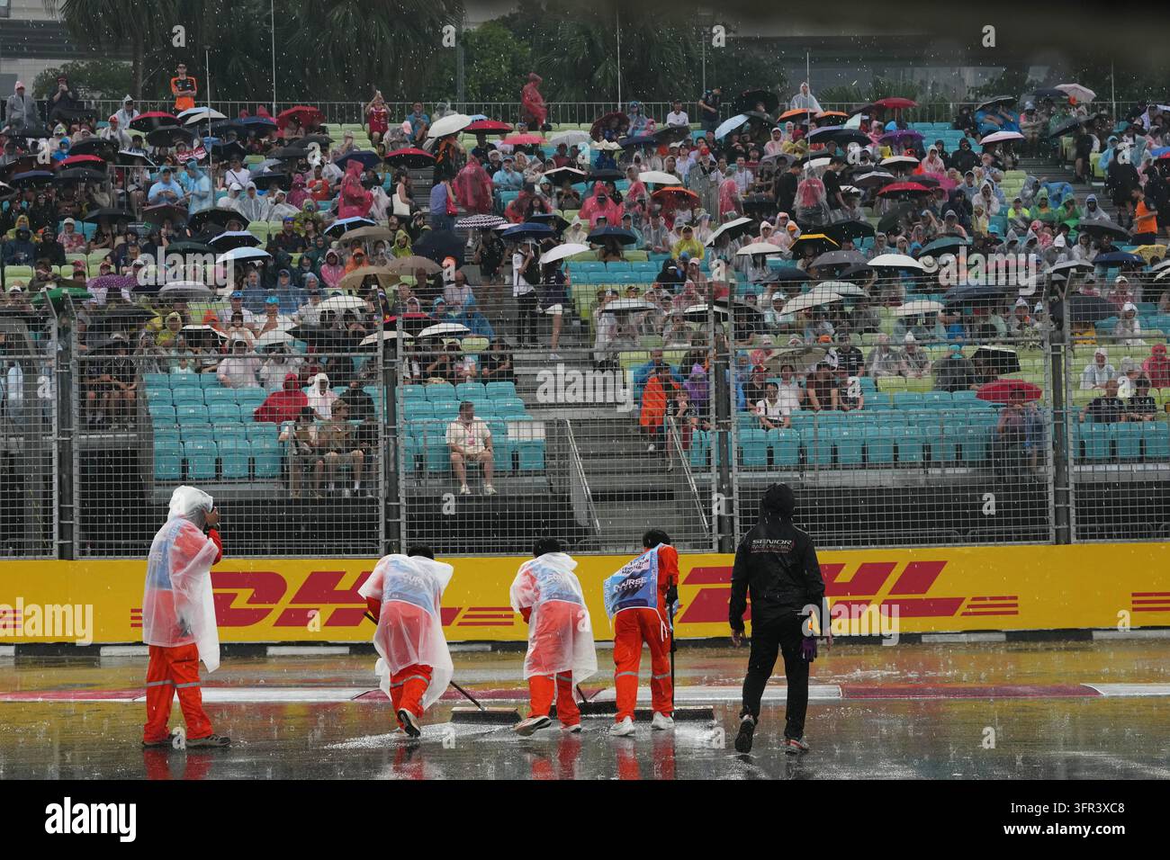 Water Races Formula Workers remove water from the track before the start of the sprint race ...