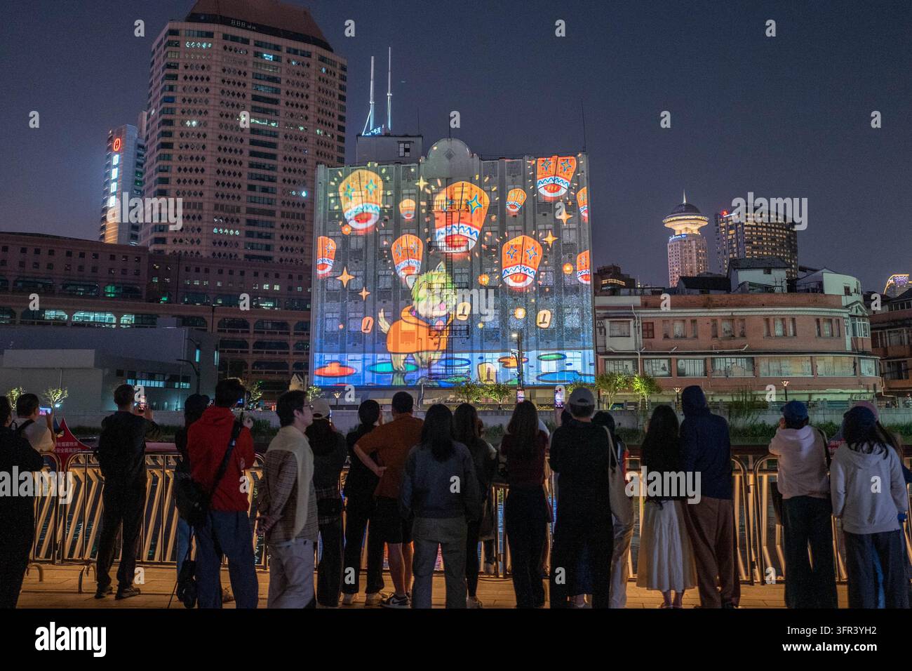 Citizens watch a light show at the Suhe Bay waterfront platform in ...