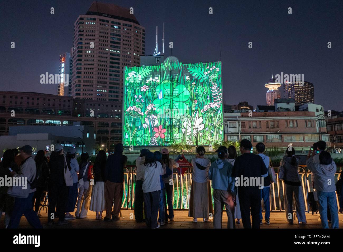 Citizens watch a light show at the Suhe Bay waterfront platform in ...