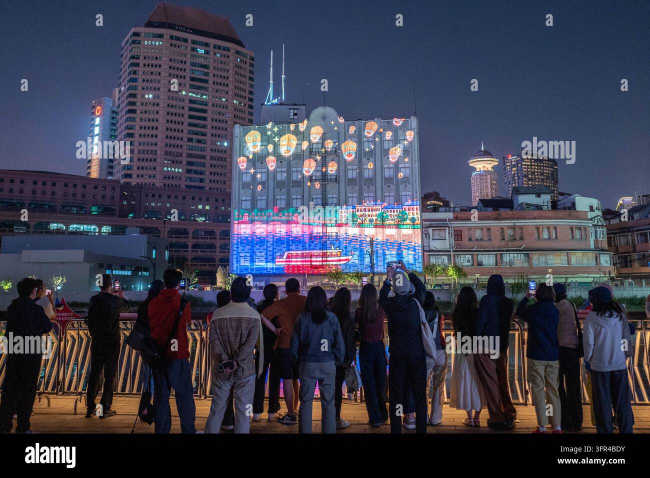 Citizens watch a light show at the Suhe Bay waterfront platform in ...