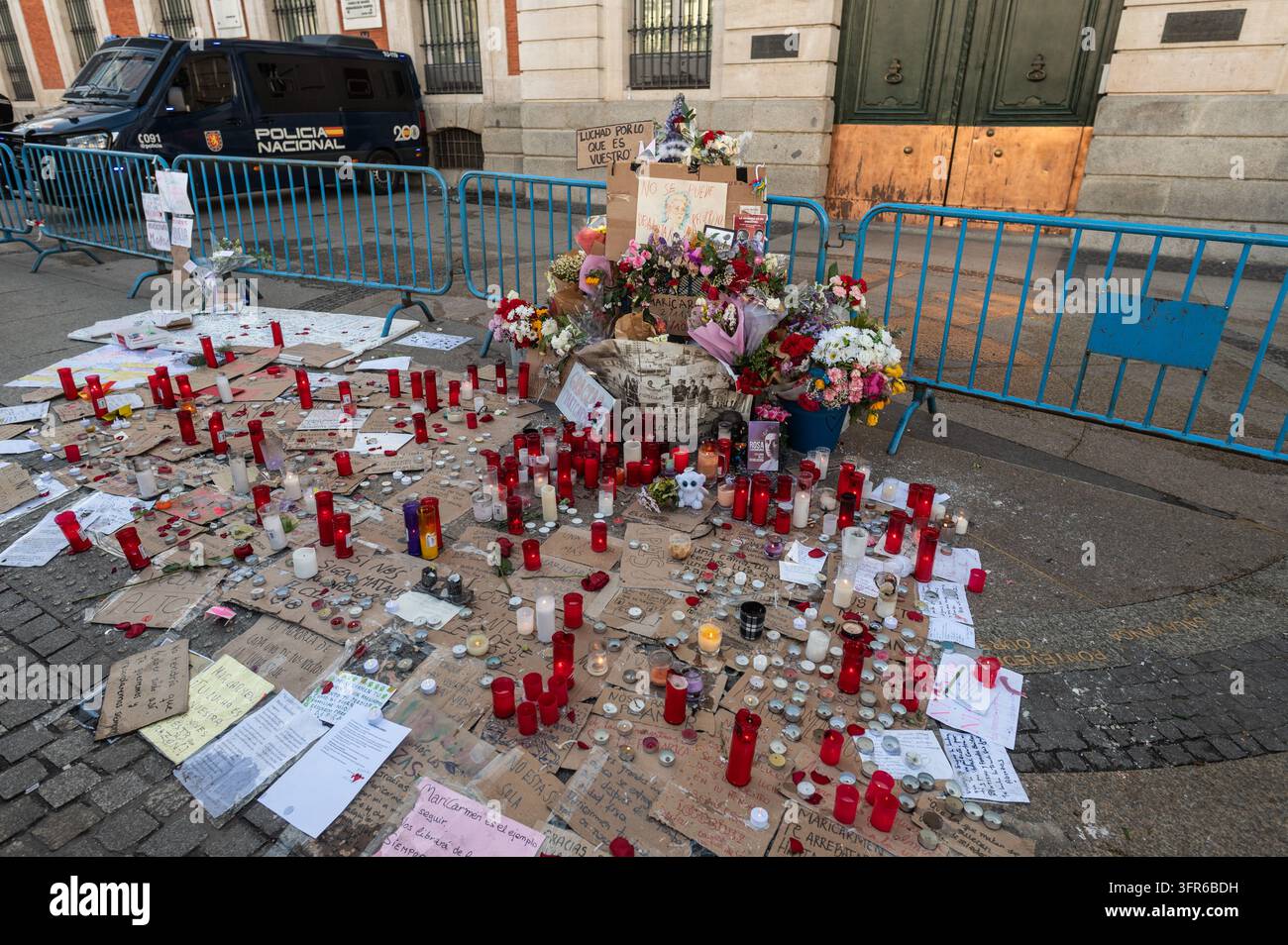 Candles are placed in memory of Maricarmen Abascal at Puerta del Sol ...