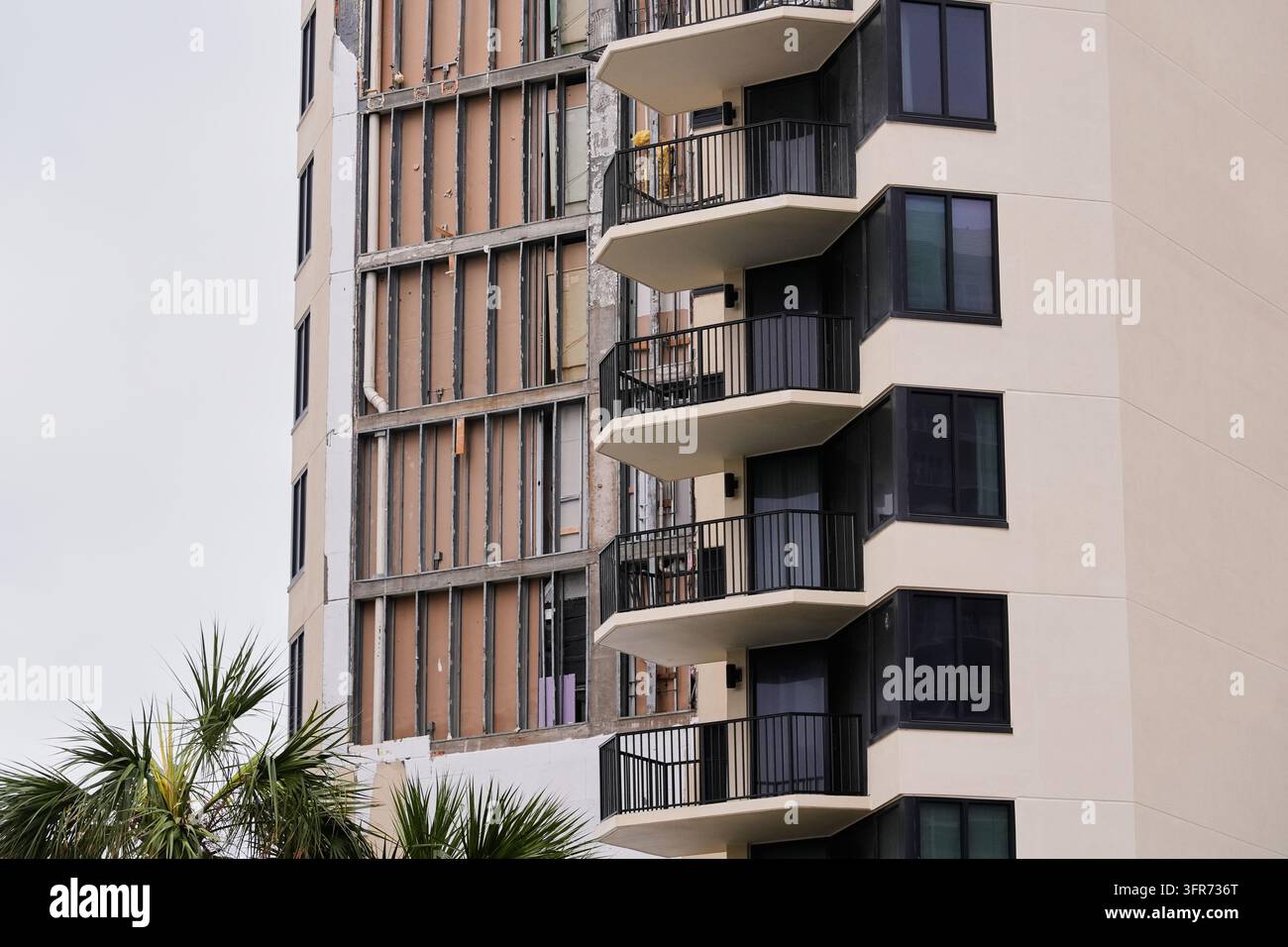Damage is seen as a side of a condominium high-rise collapsed from ...