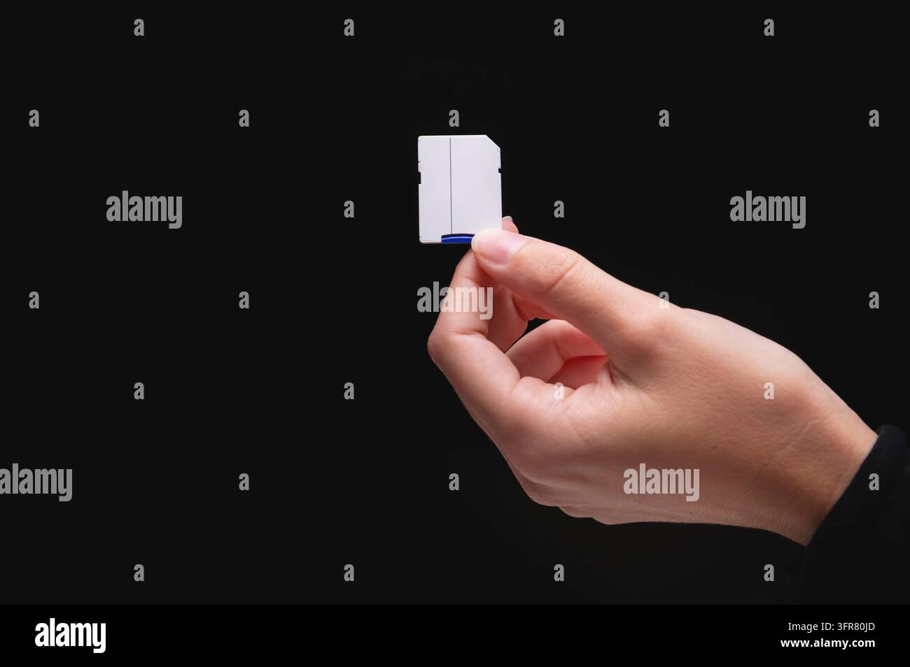 New fast micro SD memory cards and SD card adapter in hand on black background Stock Photo