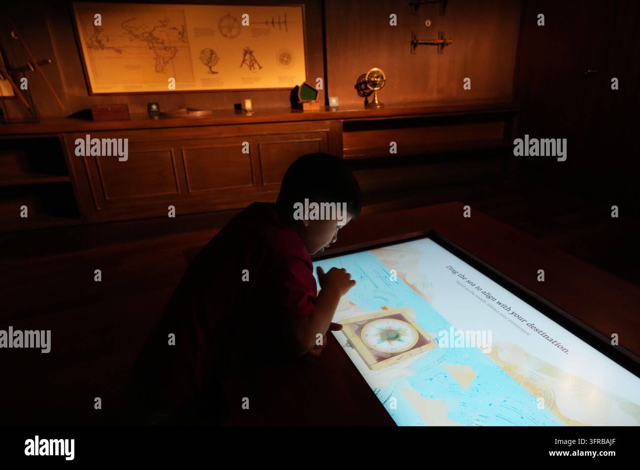 A visitor watches an interactive screen inside the full-scale ...