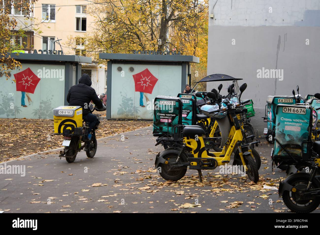 A Yandex food delivery courier rides his scooter in Moscow, Russia ...