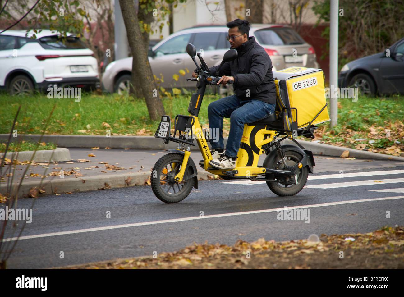A Yandex food delivery courier rides his scooter in Moscow, Russia ...