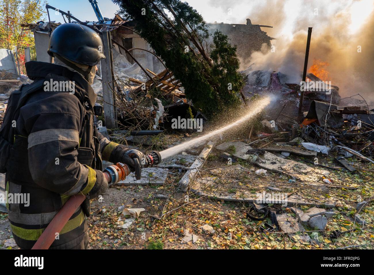 File Rescue Software A rescue worker puts out a fire at residential houses destroyed in a ...