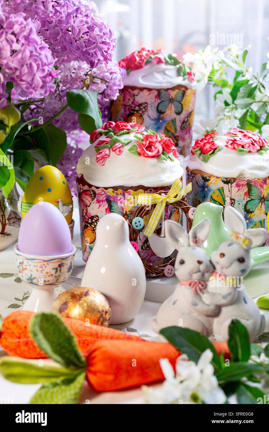 Festive Easter table with Easter cakes, eggs and flowers, selective focus Stock Photo