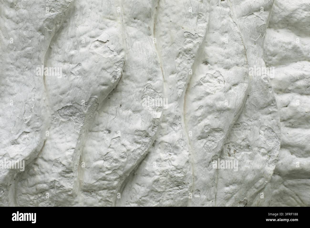 Texture is white. Sculpture details. White washed surface. Background is from lumps. Stone waves Stock Photo
