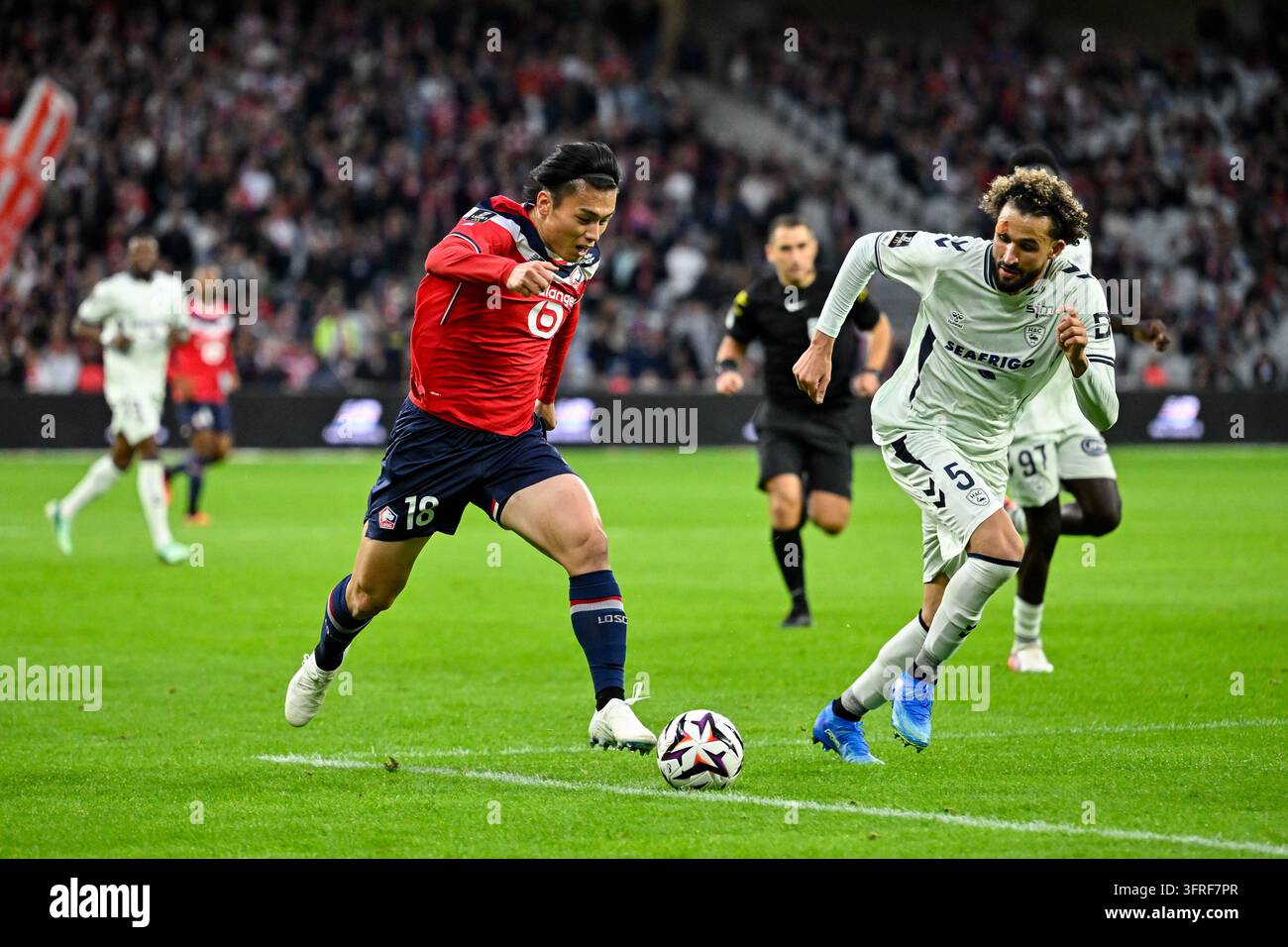 Ayase UEADA of Lille and Ahmed TOUBA of Le Havre during Ligue 1 ...