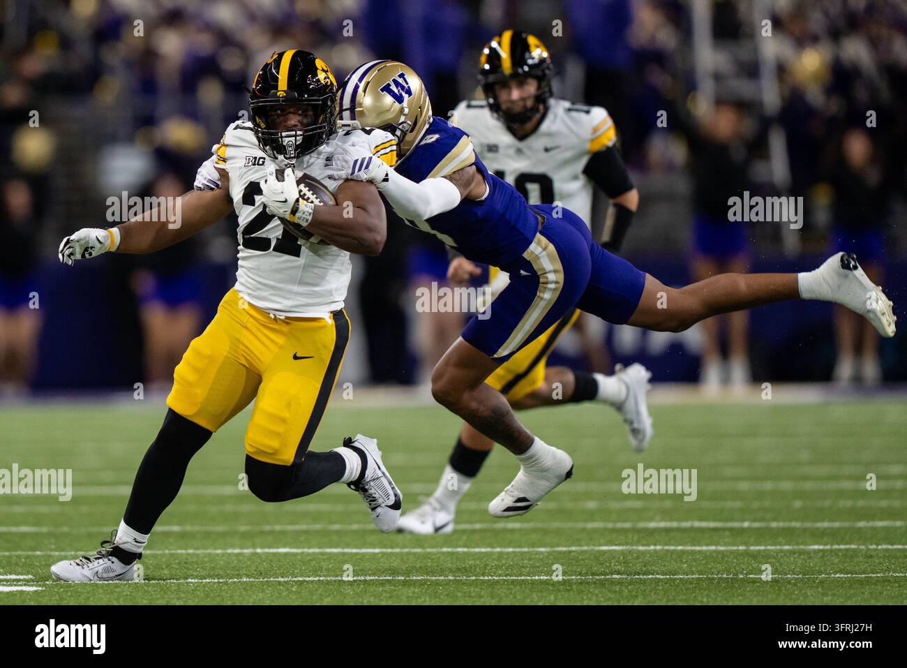 Iowa runningback L.J. Phillips Jr., left, runs with the ball against ...