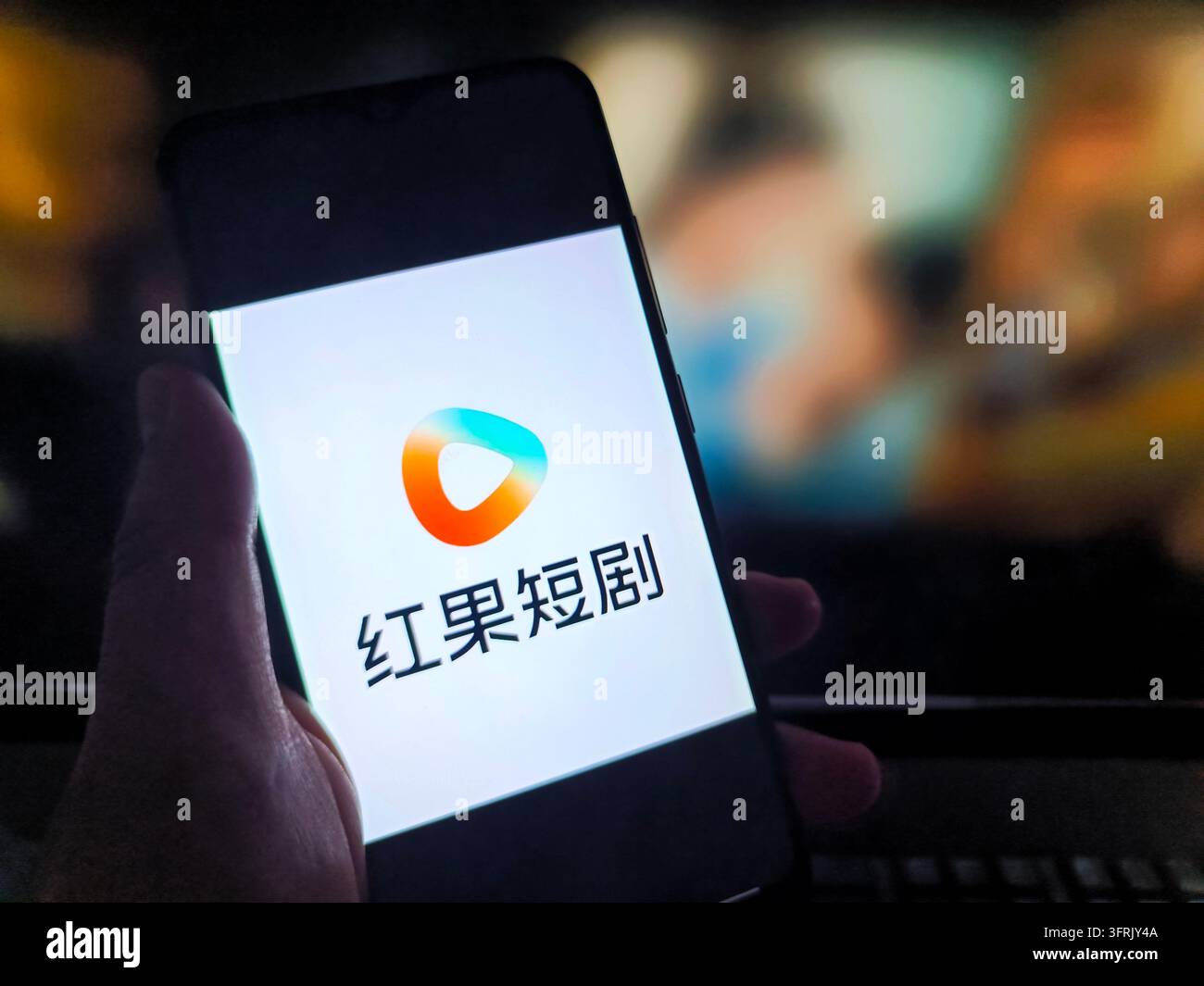 SUQIAN, CHINA - OCTOBER 12, 2026 - A netizen is using his mobilephone ...