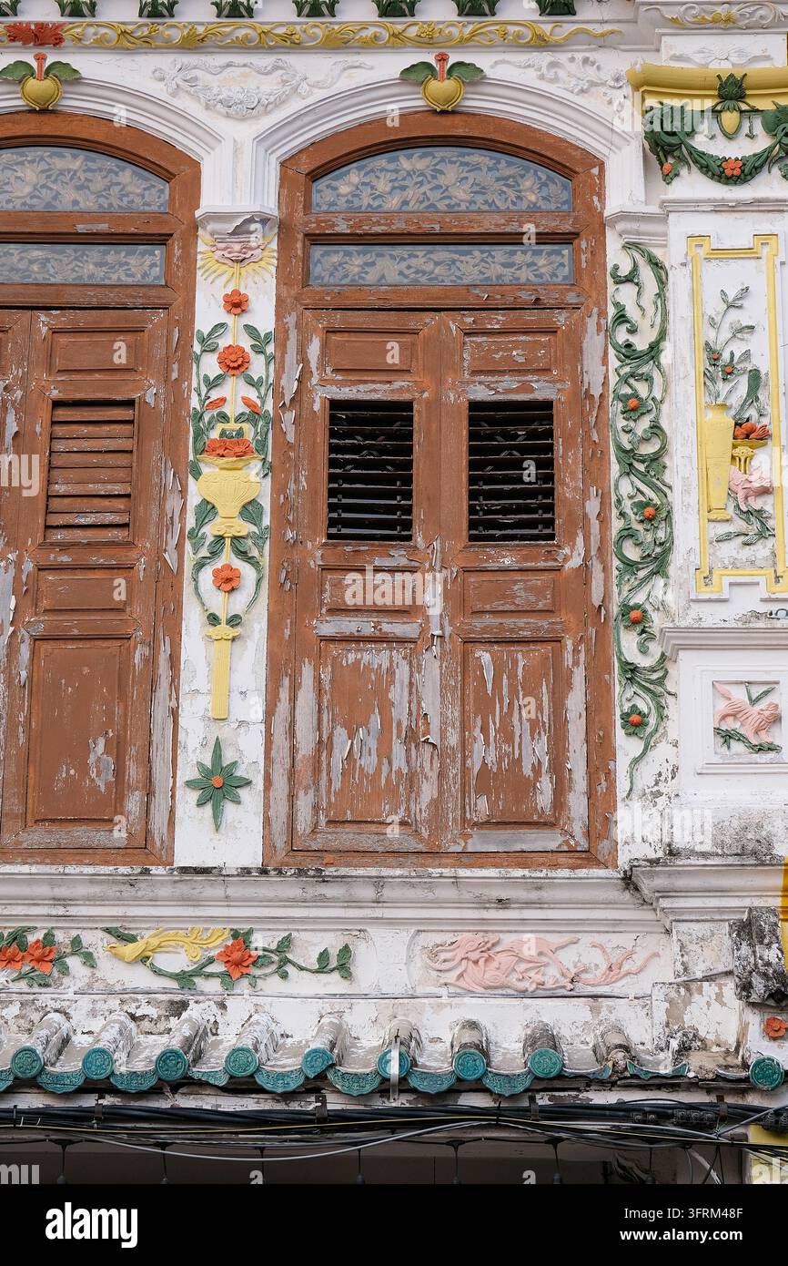 Vertical architectural detail of weathered wooden shutters and colorful ...