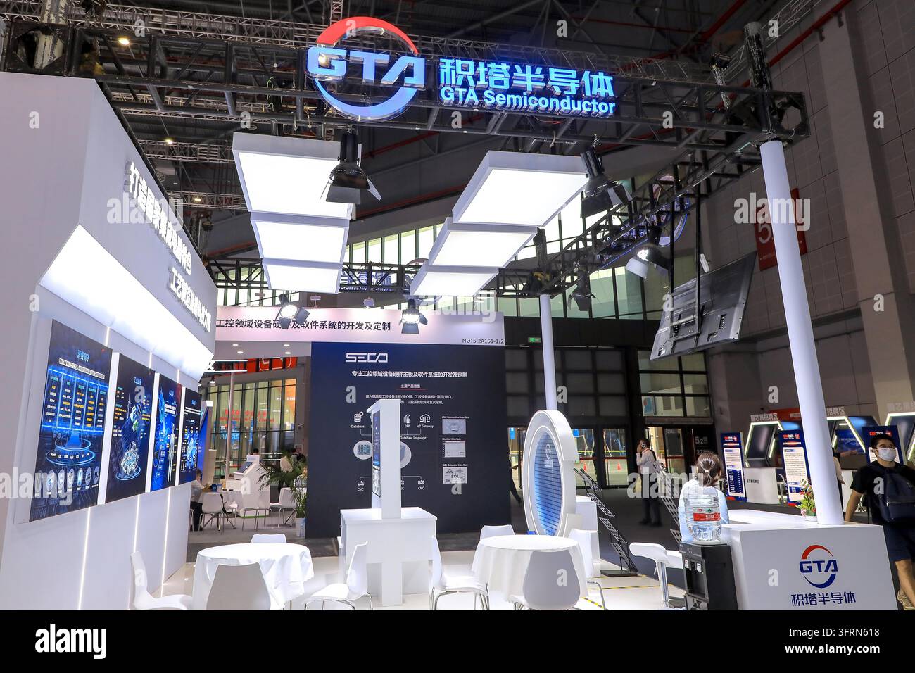 An exhibitor displays products at the first integrated circuit ...