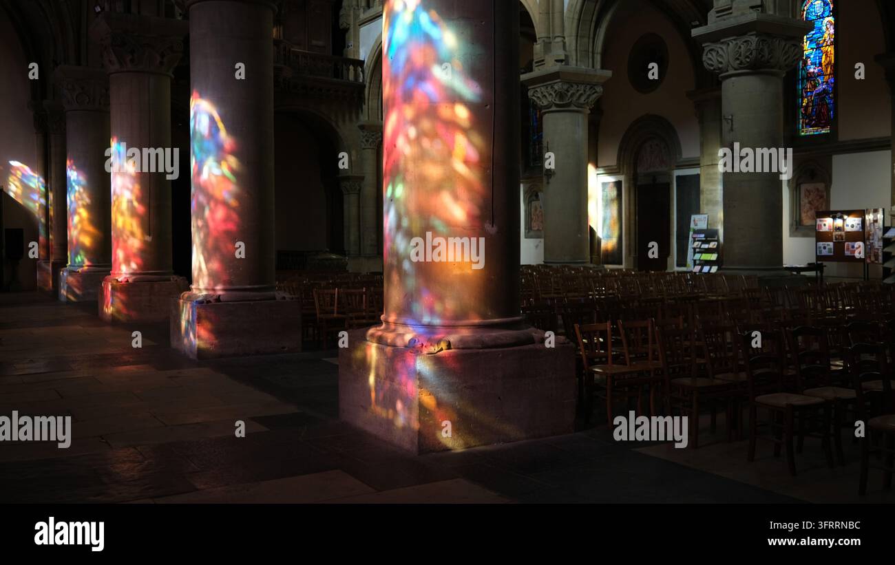 Colou Read Coloured light shining through the stained glass window onto the colums ...