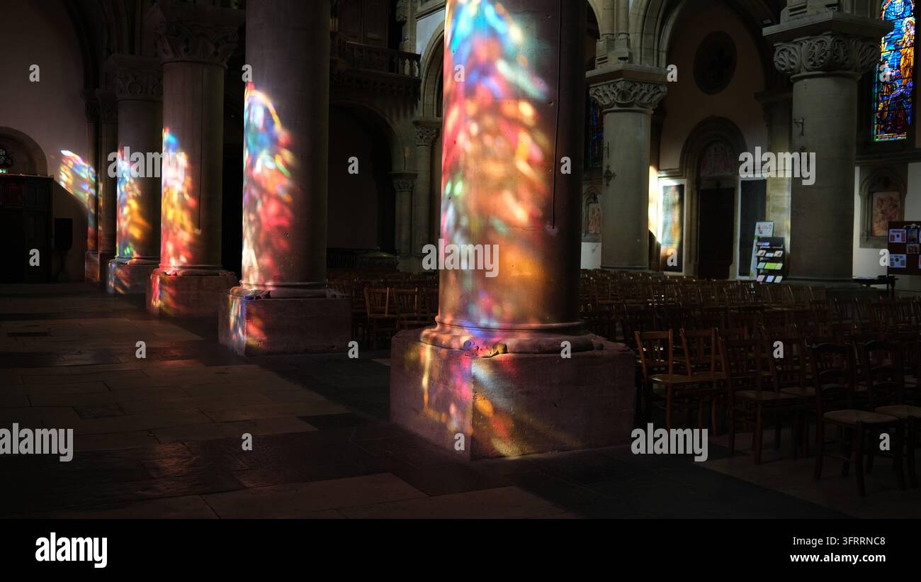 Colou Read Coloured light shining through the stained glass window onto the colums ...
