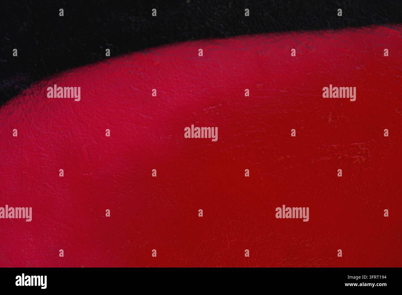Abstract close-up of red black painted wall texture, curved edge ...